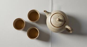 Teapot and Cups Filled with Tea Viewed From Overhead photo