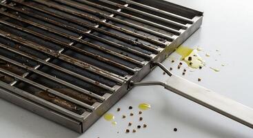 Grill Basket with Splattered Oil and Spices Ready for Cooking photo