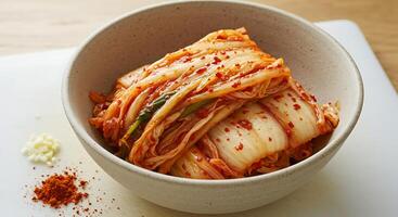 Serving of Fresh Kimchi in a Bowl with Seasoning on Table photo
