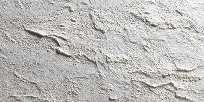Close-up of textured white plaster wall surface photo