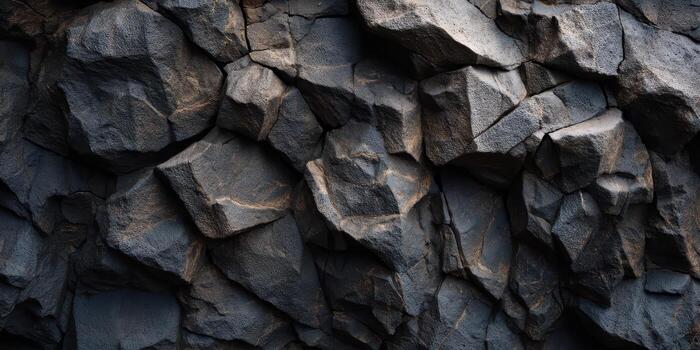 Close up view of dark textured rough rock surface detailed photo