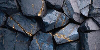 Close up of dark rocks with gold mineral veins photo