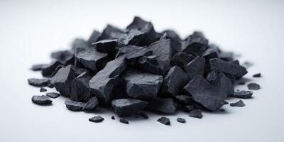 Close Up of Black Charcoal Pieces on White Background photo