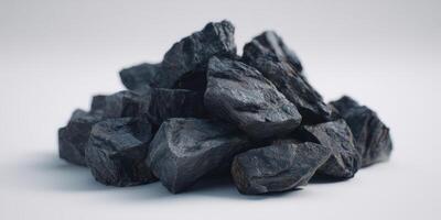 Close up of black coal mineral rock pile on white background photo