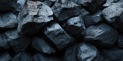 Close up of dark raw coal chunks stacked tightly photo