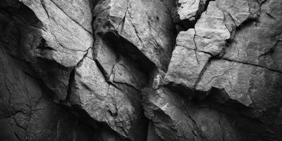 Close up of rugged natural grey cracked rock surface photo