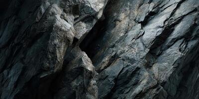 Close up texture of rugged natural rock surface in shadow photo