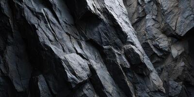 Close Up Texture of Dark Rocky Cliff Surface with Cracks photo