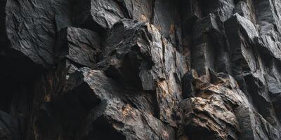 close up of textured rugged dark rocky cliff surface photo