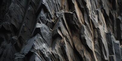 close up of rugged dark rocky cliff face texture photo