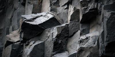 Closeup texture of natural basalt rock formation cliff face photo