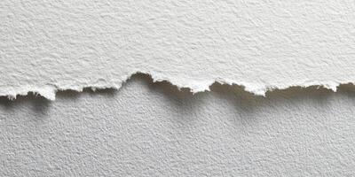 Close up of torn edge textured white paper surface photo