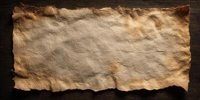 Old weathered vintage parchment paper on wooden surface photo