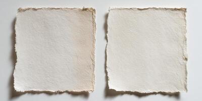 two blank textured handmade paper sheets on white background photo
