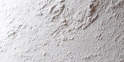 Close up of textured white stucco wall surface photo