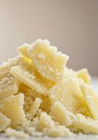 A mound of parmesan cheese flakes, capturing the essence of quality ingredients. photo