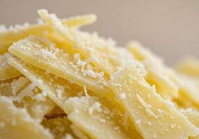 A macro shot showcasing freshly grated parmesan cheese with sliced cheese. photo