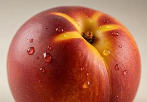 A juicy nectarine with water droplets, showcasing its vibrant colors and smooth skin. photo