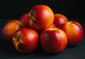 A close-up showcases a pile of fresh, ripe nectarines, bursting with vibrant colors. photo