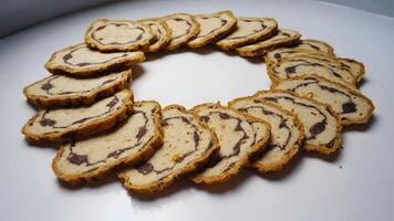 Delicious Sliced Bread or Cake Rolls Arranged in a Circular Pattern on a White Surface Freshly Baked and Appetizing Perfect for Breakfast Desserts or Snacks. photo