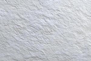 Textured white surface with subtle shadows reveals intricate details, creating a cool and calming photo