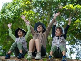 Mother takes her children to learn about nature in the forest to explore nature from the real place. Mother and children are enjoying nature outdoors, adventuring . photo
