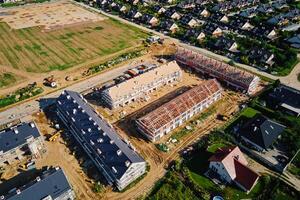 Aerial view of large suburban construction site with residential buildings in European suburb. Real estate development in small town, Building new homes photo