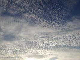 A beautiful sky filled with textured altocumulus clouds creating a soft and intricate pattern photo