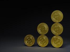 Several bitcoin coins arranged in a triangular formation. photo