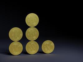 Bitcoin coins stacked in a pyramid shape on dark surface. photo