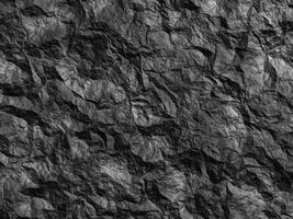 Cracked rock texture featuring sharp, angular shapes and rough surfaces. photo