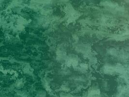 Green marble texture with soft swirls and smooth, flowing patterns. photo
