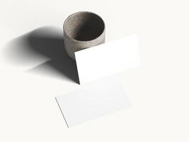 Clean white business card mockup on soft surface with gentle shadow. photo