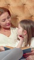 Heartwarming mother-daughter reading adventure on a cozy bed video