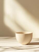 Elegant ceramic bowl on neutral pastel gradient background for minimalistic decor concepts photo