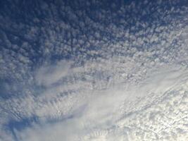 A beautiful sky filled with textured altocumulus clouds creating a soft and intricate pattern. photo