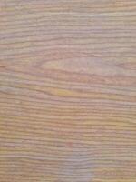 Natural wooden texture with smooth grain patterns in soft brown and yellowish tones, ideal for backgrounds and material design photo