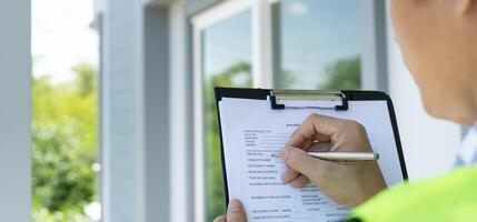 inspector or engineer check construction and quality assurance new house using a checklist. Engineers or architects or contactor work to build the house before handing it over to the homeowner photo