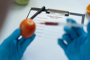 Chemical substance check list for chemical food residues in laboratory. Control experts inspect quality of fruits, vegetables. lab, find prohibited substances, contaminate. photo