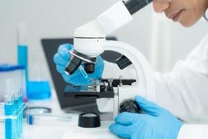 Scientist analyze biochemical in advanced scientific laboratory. Medical professional use microscope look microbiological developmental of viral. Biotechnology research in science lab. photo