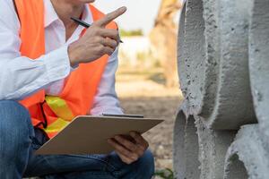 inspector or engineer is inspecting construction house using a checklist. Engineers and architects or contactor count materials for construction. Building, check, insurance house, quality, photo