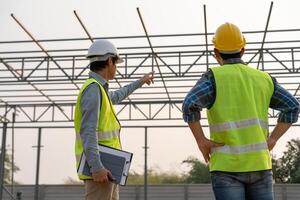 inspector and engineer is inspecting construction and quality assurance new house. Engineers or architects or contactor work to build the house before handing it over to the homeowner photo