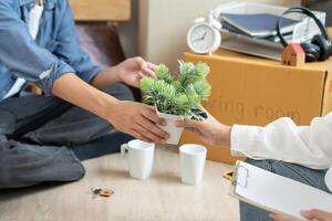 Moving house, relocation. help set and move furniture for new apartment, inside the room was a cardboard box contain personal belongings. move in the new apartment or condominium photo