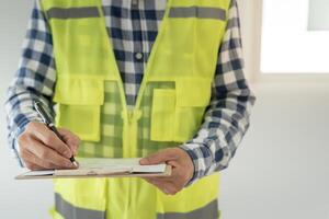 inspector or engineer inspecting construction and quality assurance new house using a checklist. Engineers or architects or contactor work to build the house before handing it over to the homeowner photo
