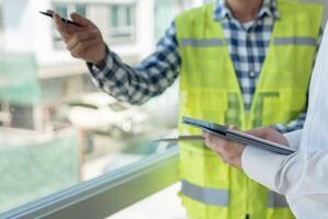 inspector engineer and owner project is inspecting construction and quality assurance new house. Engineers or architects or contactor work to build the house before hand it over to the homeowner photo
