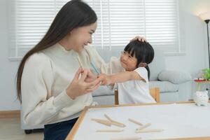 Mother day, mother play and learn draw for little girl. Funny family is happy and excited in the house. Mother and daughter having fun spending time together. Holiday, Activity photo