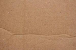 Abstract crumpled brown cardboard paper texture background design element photo