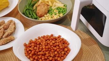 Preparing various dishes with air fryer. chicken, chickpeas, corn, and vegetables video