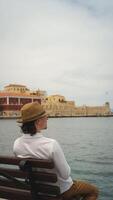 Young man enjoying the view of the venetian fortress in chania, crete photo