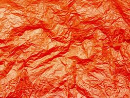 Crushed red paper texture, background photo